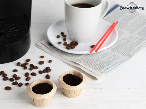 Brown Unbleached Coffee Filters For Reusable Single Serve Pods Natural Paper That Keeps Grounds Out For A Clean Smooth Brew Fits Keurig 1.0 2.0 And K Cup Pods Disposable 300 Count on table with cup of coffee and coffee beans