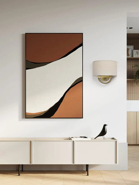 Stylish Industrial 2 Light Wall Sconce With Linen Fabric Shade above modern sideboard with abstract art in warm tones.