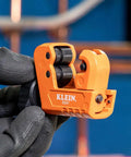 Go-To Mini Tubing Cutter For 1-1/8 Inch OD Aluminum And Copper Tubing With Spare Blade in use, held in gloved hand