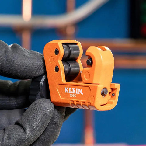 Go-To Mini Tubing Cutter For 1-1/8 Inch OD Aluminum And Copper Tubing With Spare Blade in use, held in gloved hand