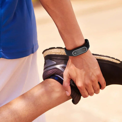 Person stretching wearing Anti Static Wrist Strap With Red Light Indicator For Esd Protection And Static Electricity Removal Unisex Black Wristband.