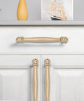 10 Pack 5 Inch Center Hole Champagne Bronze And Honey Bronze Cabinet Pulls installed on white drawer