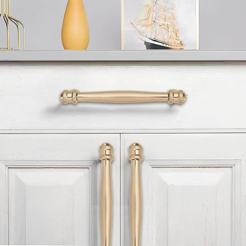 10 Pack 5 Inch Center Hole Champagne Bronze And Honey Bronze Cabinet Pulls installed on white drawer