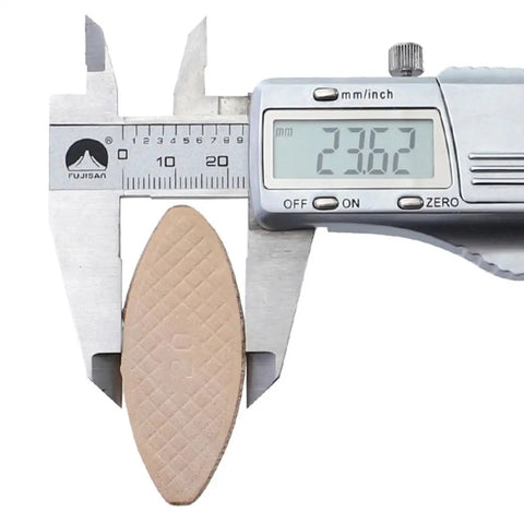 Caliper measuring thickness of a beech wood biscuit, part of 100 Pcs Wood Joining Biscuits Beech Wood Board Connection Kit.