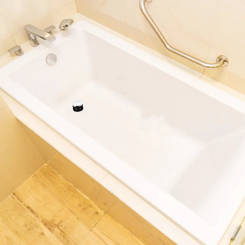 Universal Bathtub Drain Stopper Press Plug with Copper Core in a white bathtub, featuring a sleek design and ease of use.
