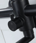 Close-up of matte black handle on wall mount kitchen faucet with side sprayer, heavy duty stainless steel commercial mixer tap.