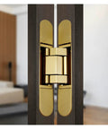 Close-up of Premium 3D Adjustable Hidden Cross Hinge for Wood Doors and Gates Self-Closing Silent Operation in gold finish.