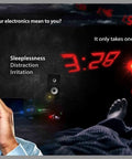 Man holding head in a room with bright digital LED clocks at night, highlighting sleep disruption without Original Strength Light Dimming Shapes Peel And Stick Dims Fifty To Eighty Percent To Reduce LED Glare In Home Office Or Car Pack Of Over One Hundred Dim Shapes.