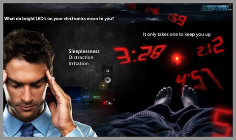 Man holding head in a room with bright digital LED clocks at night, highlighting sleep disruption without Original Strength Light Dimming Shapes Peel And Stick Dims Fifty To Eighty Percent To Reduce LED Glare In Home Office Or Car Pack Of Over One Hundred Dim Shapes.