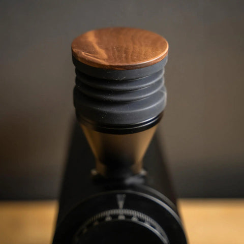 Killer Variable Speed Single Dose Coffee Grinder Equipped With 83mm Red Titanium Flat Burrs and a rock stable burr carrier in glossy black with wooden lid.
