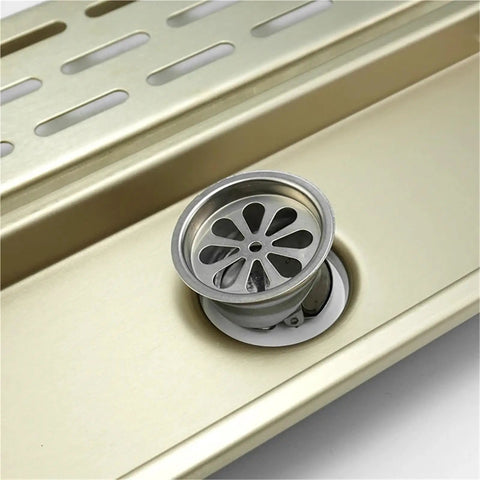 Brushed Gold Linear Shower Drain With No Sweat Hair Catcher For Bathroom Kitchen Or Toilet Durable Waste Grate, featuring a silver circular drain cover.