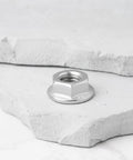 Premium Heavy Duty 4 Pack 5/16 24 Unf Stainless Steel Hex Flange Nuts Direct Swap Fit For Harley Davidson Big Twin Exhaust Manifolds on gray rock.