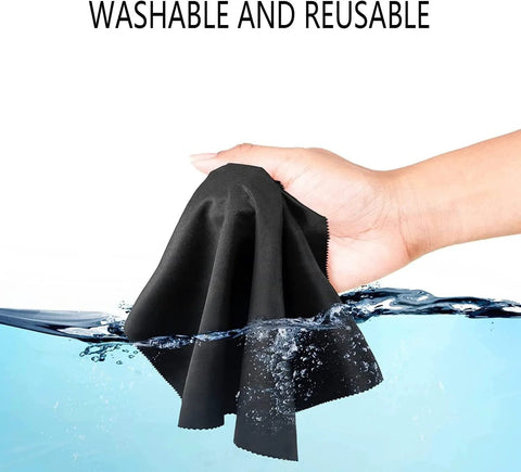 Front view of black microfiber eyeglass cleaning cloth held by hand above water.
