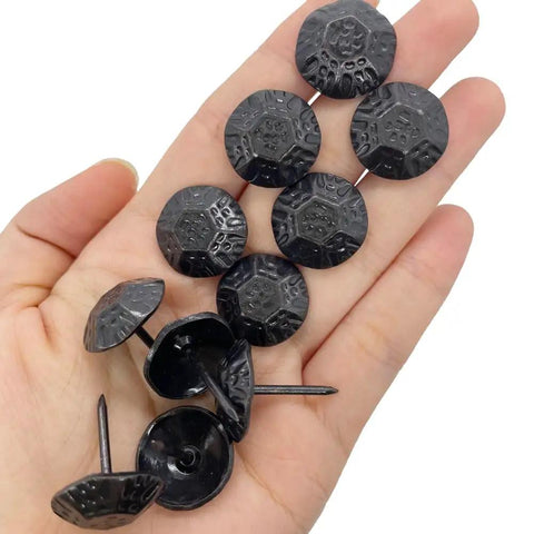 Straight Up Premium Black Metal Upholstery Tacks 100 Count With Sleek 19Mm Rounded Heads and Tough 23Mm Shafts shown in hand.