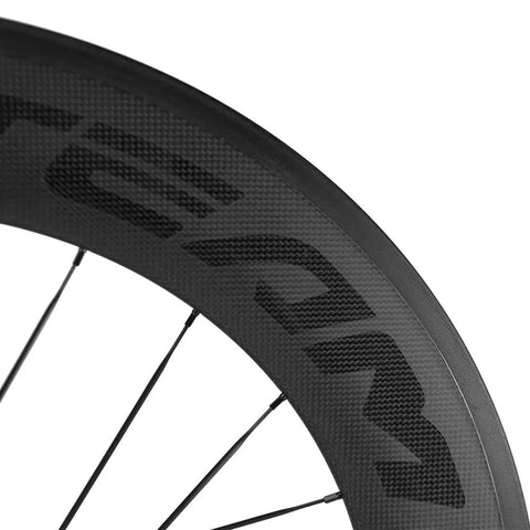 Close-up of Carbon Clincher Wheelset 700C fixed gear 60mm rim with basalt braking surface, V shape windbreak design and spoke pattern