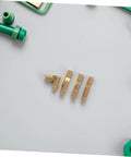 Brass Hidden Hinges Set For Wooden Boxes And Cabinets 25 Pieces Invisible Concealed Barrel Hinges with green tools on white surface