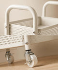 Close-up of Rock Solid Two Tier Rolling Storage Cart With No Sweat Mobility and Compact Perforated Metal Baskets white frame and wheels.