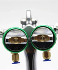 Close-up of dual nozzle spray gun with green accents and precision tips for the Professional Pneumatic Paint Sprayer.