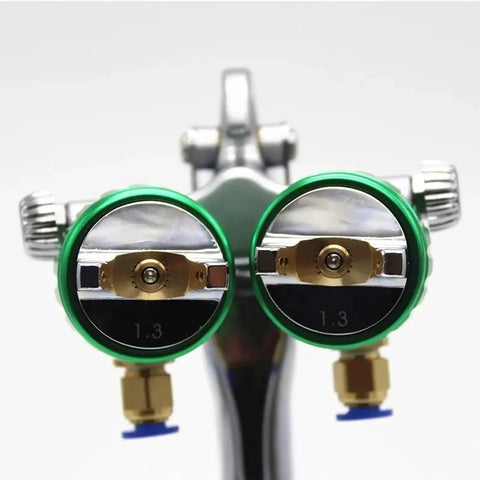 Close-up of dual nozzle spray gun with green accents and precision tips for the Professional Pneumatic Paint Sprayer.