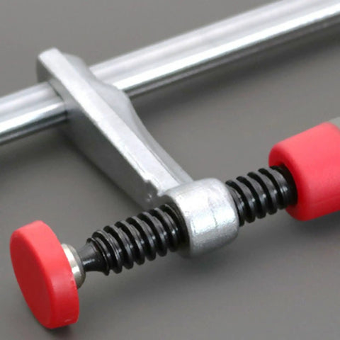 Heavy Duty Bench Dog Clamp With PP Handle, adjustable workbench stop, close-up of red handle on steel woodworking fixture