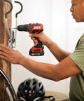 Using Compact 12V Cordless Drill Driver Featuring Brushless Tech One Half Inch Keyless Chuck to install hooks on a wooden wall
