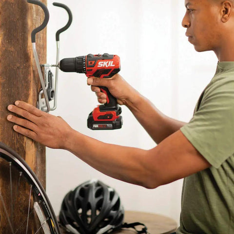 Using Compact 12V Cordless Drill Driver Featuring Brushless Tech One Half Inch Keyless Chuck to install hooks on a wooden wall