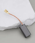 Single black motor carbon brush with copper wire connector for Hilti power tools, 7x12.5x25mm size.