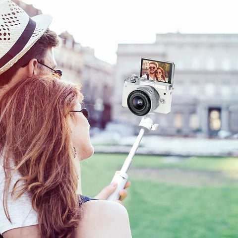 Couple using MT-08 White Mini Tripod For Camera With 1 Quarter Inch Mount 2 In 1 Extendable Handheld Video Stand for selfies