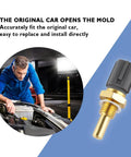 Close-up of engine coolant temperature sensor with brass stem and gray plastic connector; mechanic inspecting engine in background.