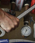 Using a Seven Piece SAE Wrench Set With Open End Grooves For Corner Protection on a control valve, showing hand grip and tool application.