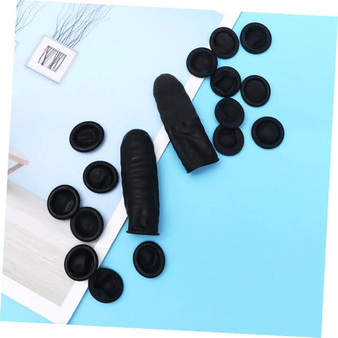 Heavy Duty 1000 Pack Finger Sleeve Protectors Soft Latex Tip Guards Sick Grip For Mechanics Factory Workers Guitar Shredders And Sewing Crew Lightweight Daily Grind Essential black latex fingertip guards scattered on blue background.