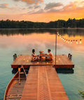 Couple dining on dock at sunset with Outdoor String Lights 30ft With 25 Plus 2 Spare LED Filament Bulbs, Dimmable, Shatterproof And Waterproof.