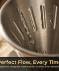 Interior view of reusable stainless steel coffee dripper for pour over coffee, large V shaped filter with handle, showing ribbed design
