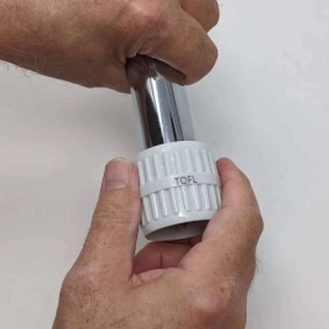 Stainless steel pipe reamer tool with white adjustable cap labeled TOFL, used on pipes