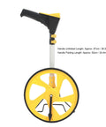 Tough Foldable Digital Measuring Wheel With Telescopic Shaft And Sweet Backlit Readout Includes Compact Tape Measure showing yellow wheel and folding handle.
