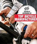 Person applying Heavy Duty Built Tough Bike Grease With High Pressure And Water Resistant Formula For Rust And Corrosion Protection