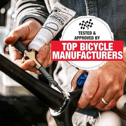 Person applying Heavy Duty Built Tough Bike Grease With High Pressure And Water Resistant Formula For Rust And Corrosion Protection