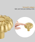 Close-up of 8 Pack Gold Brushed Brass Cabinet Knob with smooth edges, decorative solid zinc alloy handle, and finger pointing at knob.