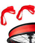 Fat Tire Rim Liner Strips And Rim Tape PVC Inner Tube Protector for 26x4.0 MTB bikes in red, shown near a bicycle wheel rim