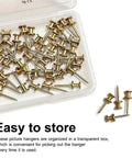 Heavy Duty Double Headed Picture Hangers And Thumb Tacks Pack Of Fifty Pieces For Hassle Free Wall Mounting With A Rock Solid Grip organized in a transparent box.