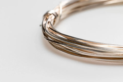 Close-up of 12 Gauge 925 Sterling Silver Wire Dead Soft Square Made In USA 5 Ft for jewelry making and wire wrapping, coiled view.