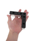 Close-up of a hand holding 4 Pack L Shaped Aluminum Furniture Legs With Plastic Bases For TV Stands And Woven Sofa Frames