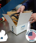 Person handling a box with contents labeled West Michigan Based, showcasing a product related to the region.