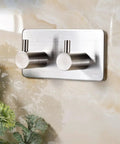 Heavy Duty Stainless Steel Wall Mounted Hooks Featuring Super Strong Self Adhesive Tape For Bathroom Towels Coats And Home Organization No Drill Hassle Rust Proof Daily Setup on smooth wall.