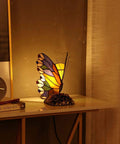 Butterfly Tiffany Style Stained Glass Accent Table Lamp Night Light illuminating a room with a cozy warm white glow, 8x5x9 inches.
