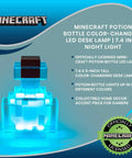 Potion Bottle Color Changing LED Desk Lamp With Pixelated Design glowing in blue, 7 inch night light for gamers, battery powered.