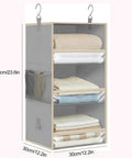 3 Tier Hanging Closet Organizer With Adjustable Detachable Shelves And Clear Window Panels displaying neatly folded blankets and towels.