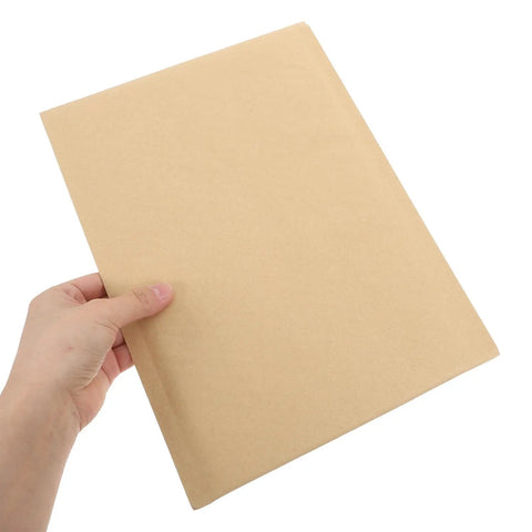 Khaki Kraft Bubble Mailers Set 22x34cm Drop Resistant Padded Envelopes Self Sealing Shipping Pouches held by a hand