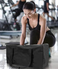 Person with Beefy 56L 24Inch Sports Duffel Bag Set With Upgraded Zipper Water Resistant Foldable Gear Tote in gym setting