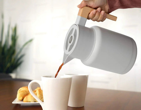 Pouring coffee from 50 Oz Thermal Coffee Carafe Stainless Steel Insulated Dispenser Keeps Your Brew Hot Or Cold For Hours in kitchen